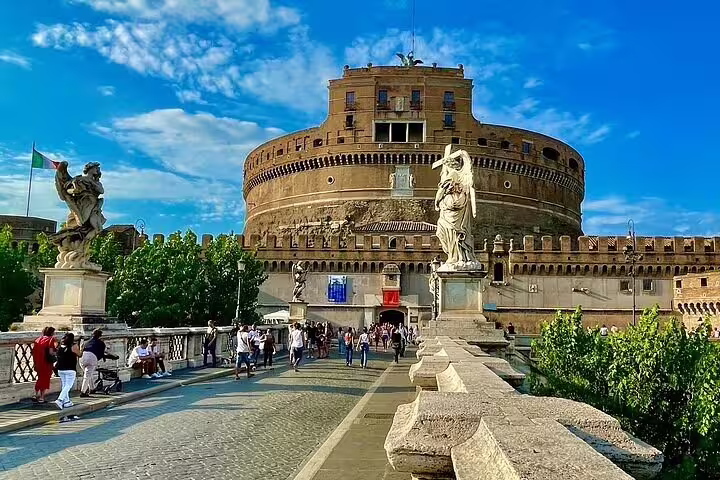Tourists crossing Ponte Sant’Angelo toward Castel Sant’Angelo in Rome on a guided private chauffeured sightseeing tour