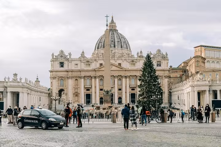 Visitors admire the Christmas tree and architecture at St. Peter's Basilica, a key stop on a Rome private tour.