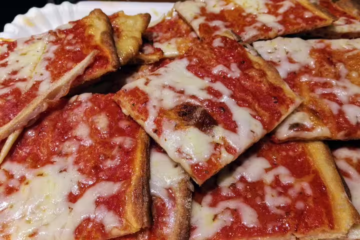 Authentic Roman pizza al taglio with tomato sauce and mozzarella on Rome street food tour