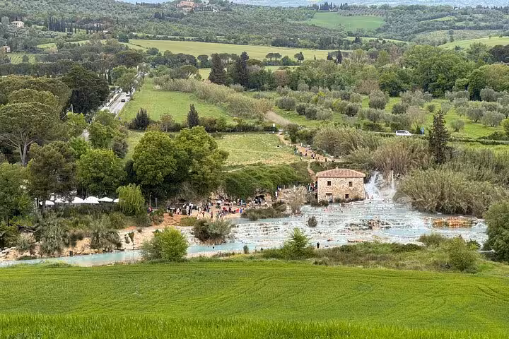 Aerial view of Terme di Saturnia's cascading thermal waters nestled in the scenic Tuscan countryside.