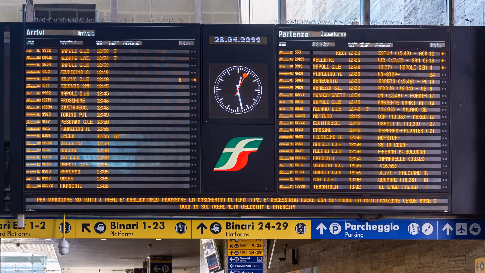 Digital train schedule display at Rome Termini station, ideal for private one-way transfer to city center.