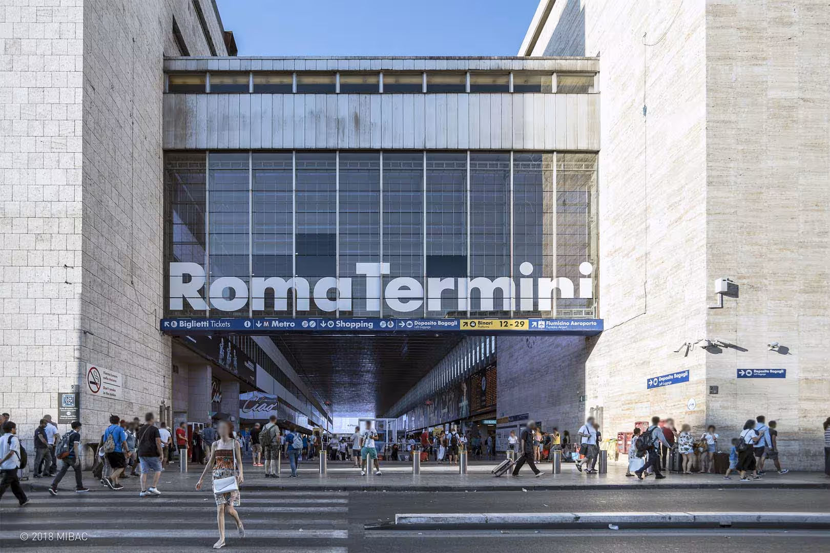 Exterior of Rome Termini station bustling with travelers, highlighting private transfer service to city center.