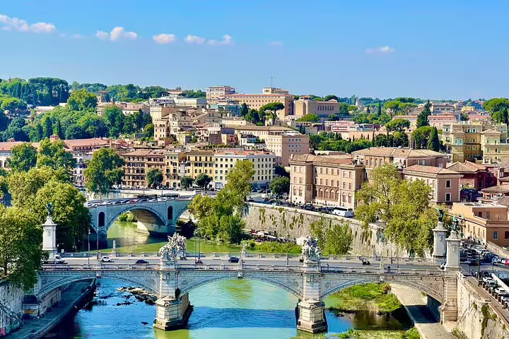 Aerial view of bridges over the Tiber and historic riverside buildings in central Rome on a chauffeured 3-day city tour