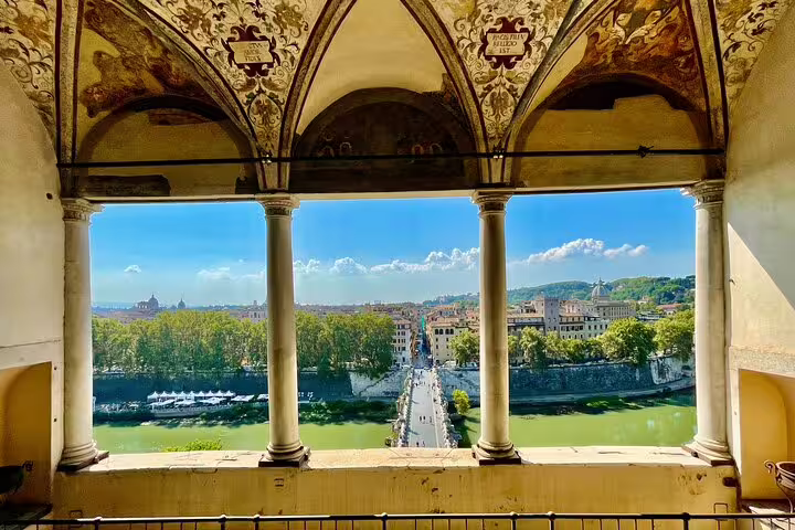 Panoramic view of central Rome and the Tiber River framed by ornate arches on a private chauffeured sightseeing tour
