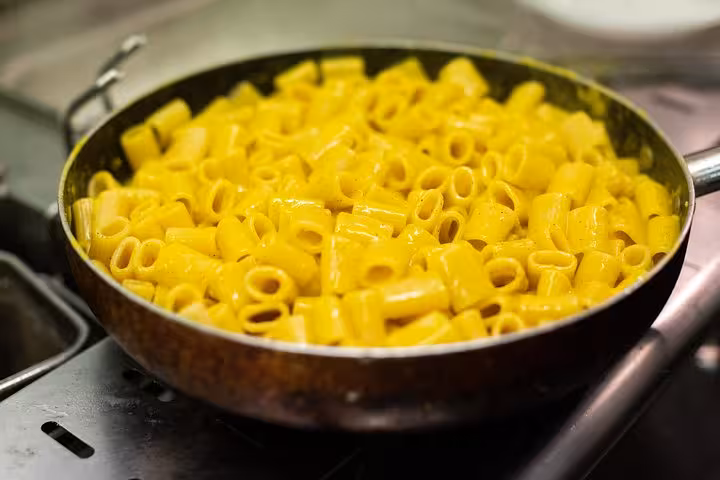 Savor authentic Italian cuisine with a pan of creamy rigatoni pasta, a highlight of the Trastevere food tour.