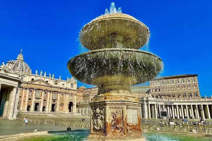 Baroque fountain in St Peter’s Square with Vatican basilica backdrop on a Rome Private VIP Vatican Museum and Sistine tour