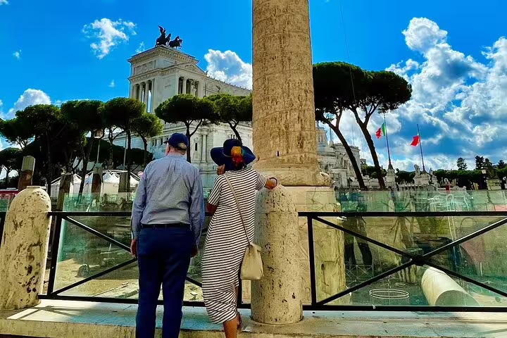 Couple admiring Vittoriano monument and Roman ruins on skip-the-line Rome and Vatican City shore excursion from Civitavecchia