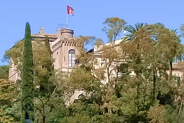 Scenic view of a historic villa surrounded by lush greenery, captured on a Vespa tour through Rome's highlights.