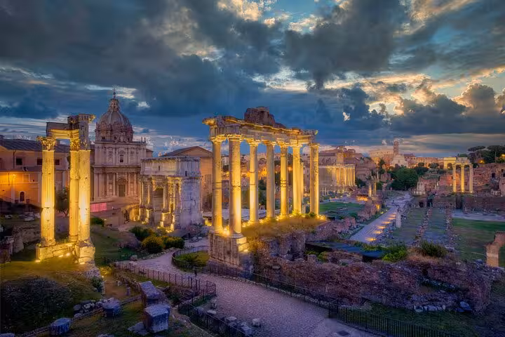 Roman Forum at sunset on a Rome walking tour, illuminated ruins and ancient columns near Vatican access