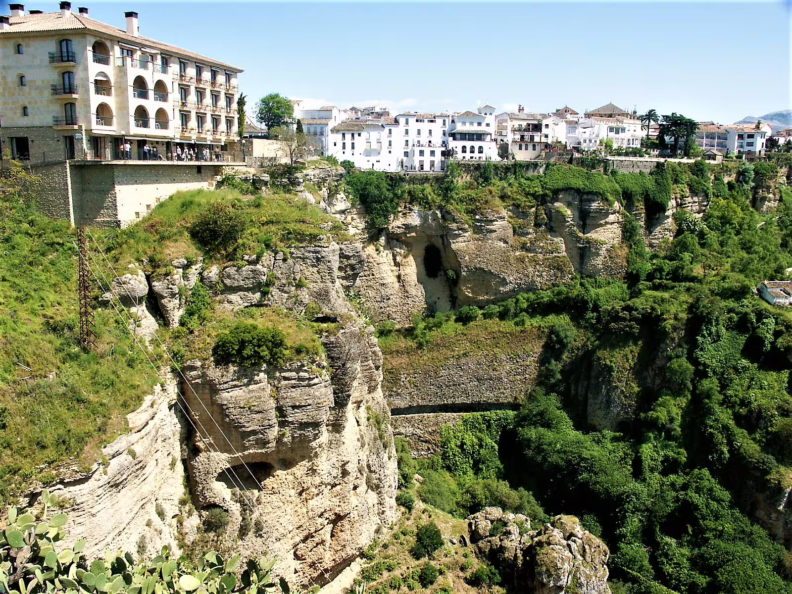 Panoramic view of Ronda’s El Tajo gorge and cliffside old town, highlight on a guided group walking tour