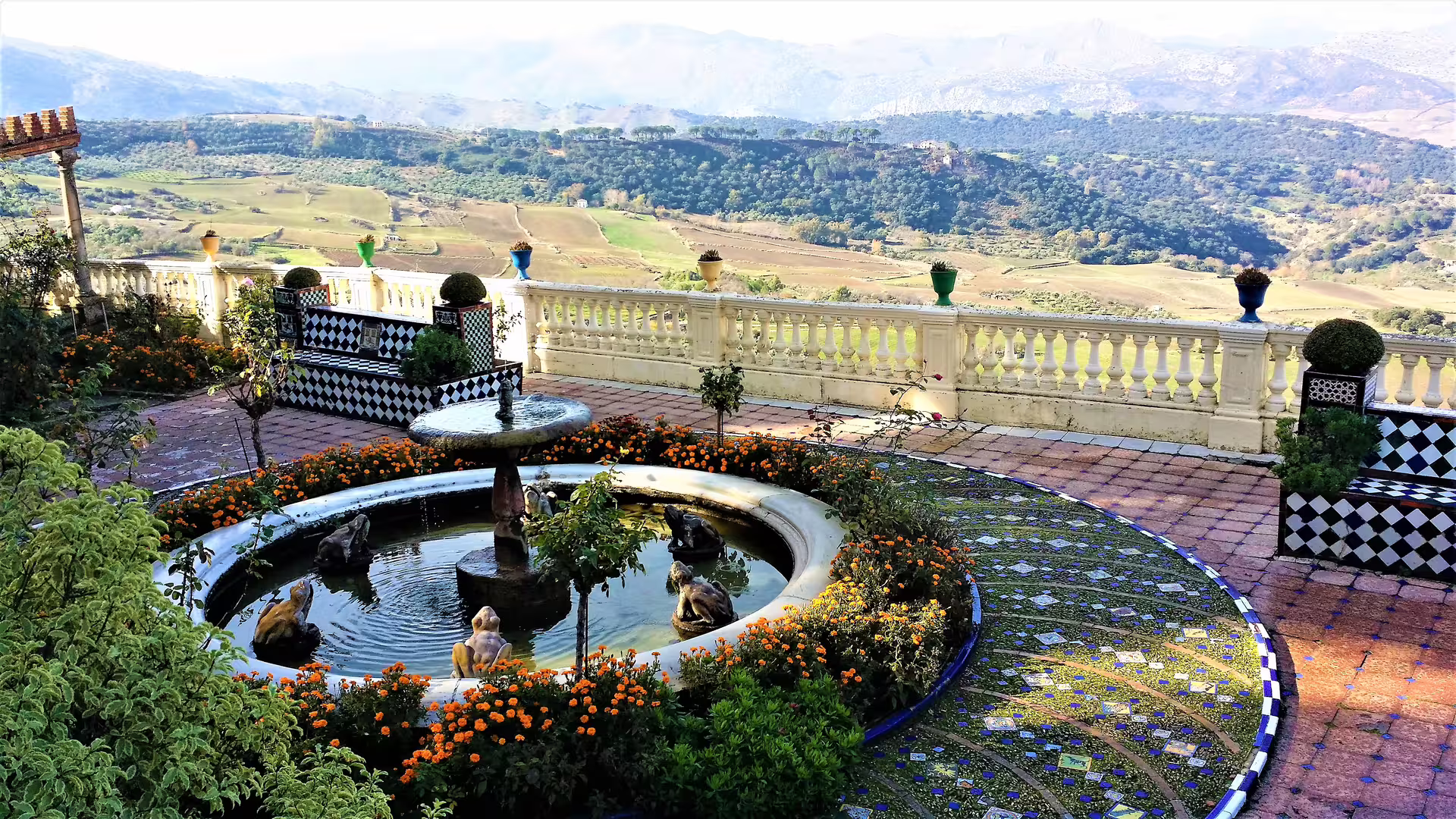 Ronda group walking tour view of Cuenca Gardens fountain, tiled terrace and sweeping Andalusian valley