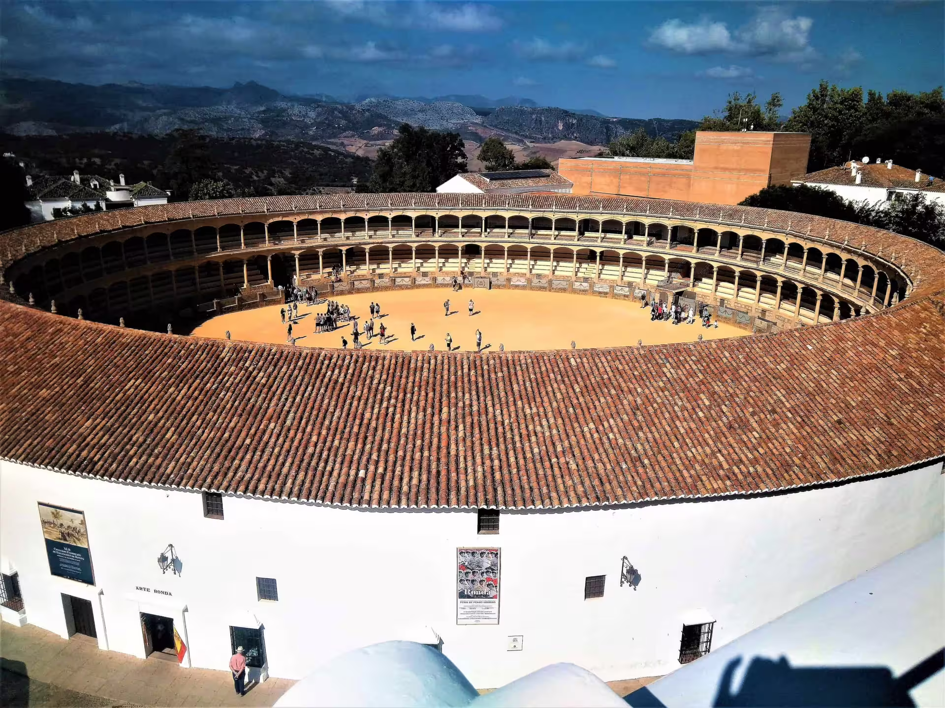 Ronda group walking tour at the historic Plaza de Toros bullring, panoramic view of the arena and mountains