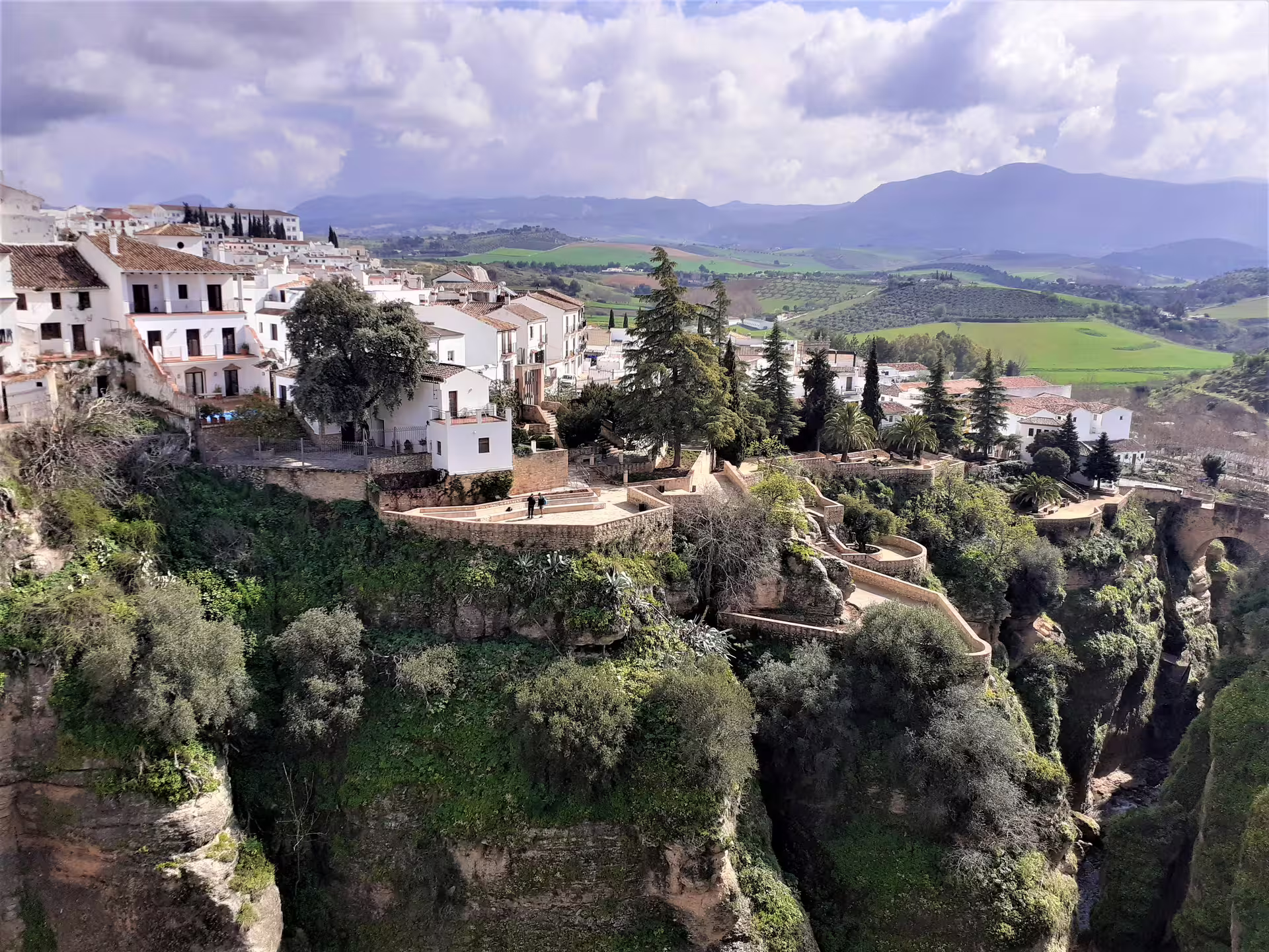 Scenic Ronda group walking tour view of whitewashed old town above El Tajo gorge with Andalusian countryside