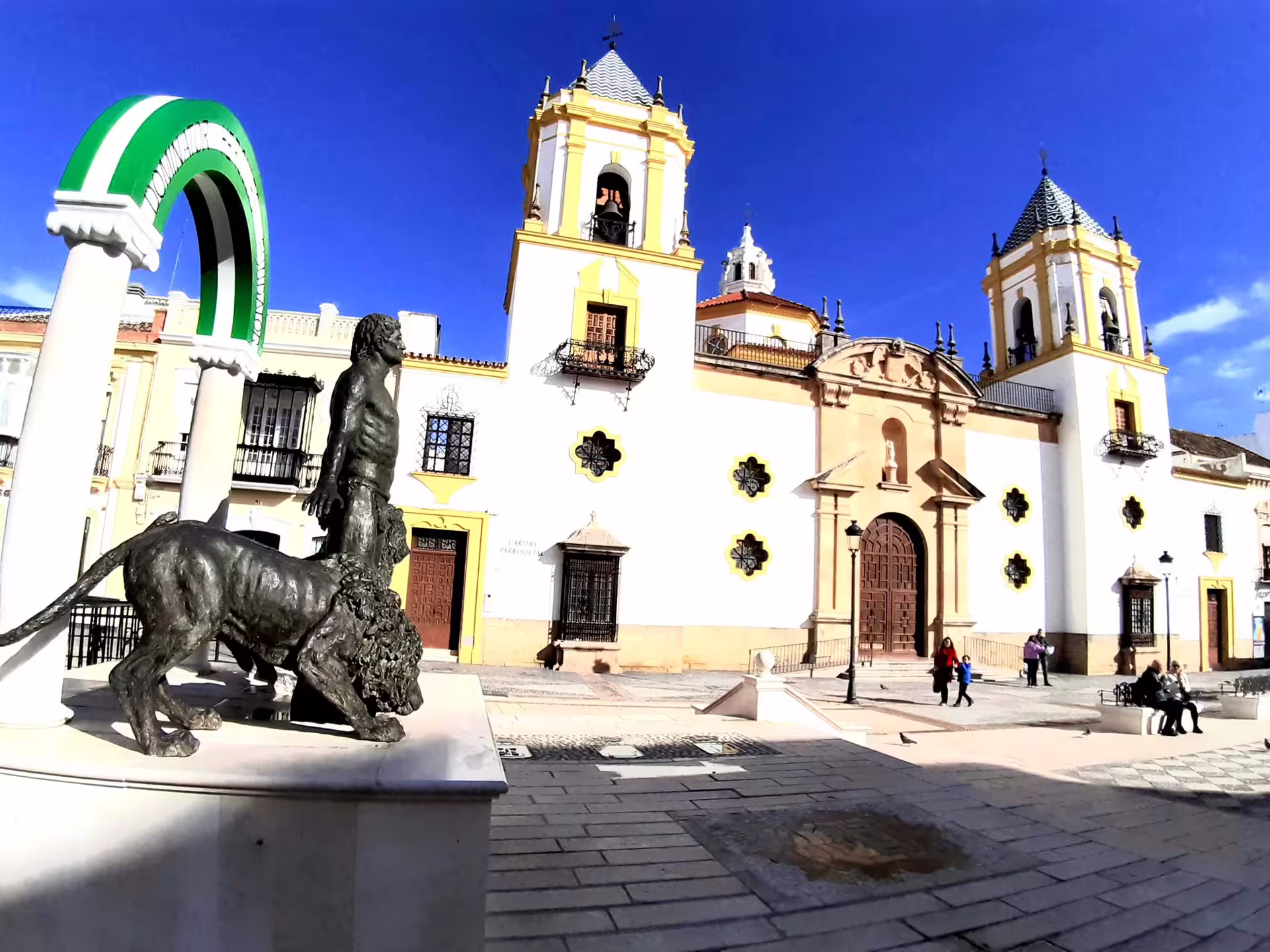 Ronda historic center with Iglesia de Santa María la Mayor and statue, on a private tour from Costa del Sol