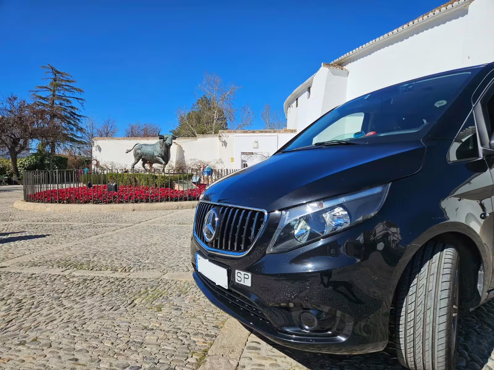 Private transfer van in Ronda near bull statue, Costa del Sol day trip with driver and pickup service