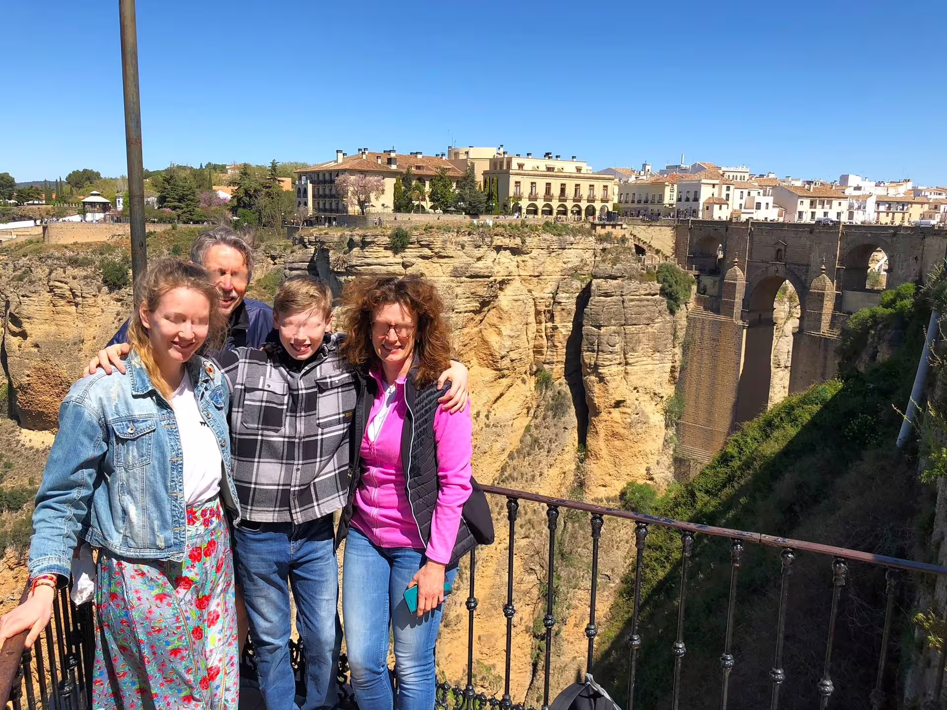 Family photo at Ronda Puente Nuevo viewpoint over El Tajo gorge on a private tour from Costa del Sol