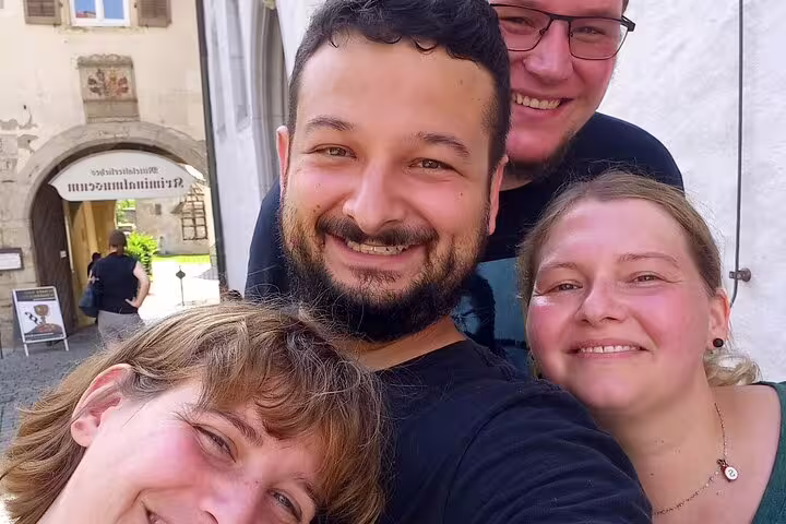 Friends take a selfie by Rothenburg city gate during a self-guided scavenger hunt walking tour