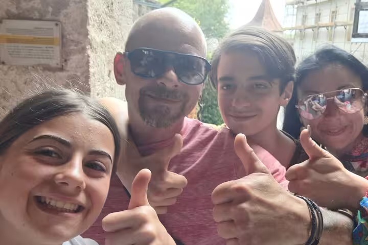 Family selfie giving thumbs up on Rothenburg scavenger hunt self-guided walking tour in the old town