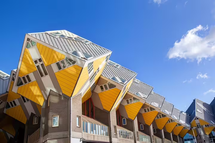 Rotterdam cube houses with bold yellow tilted facades against a bright blue sky
