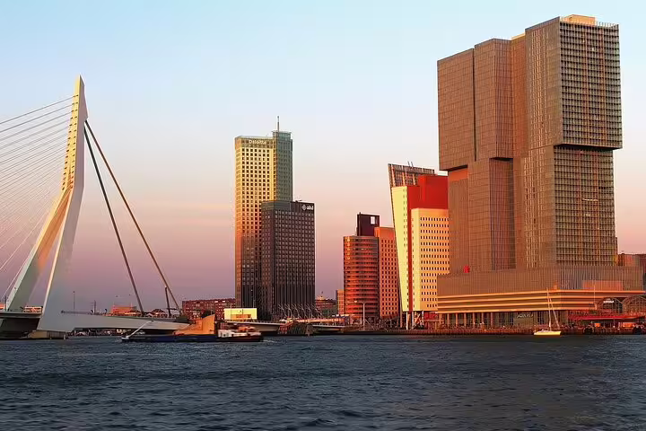 Rotterdam skyline at sunset with Erasmus Bridge and modern waterfront, seen on Amsterdam to Rotterdam private tour