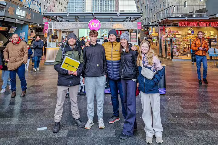 Happy group with Dutch local guide at Rotterdam city center on highlights and hidden gems walking tour experience