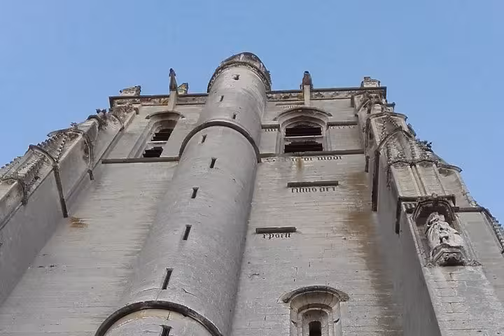 Looking up at the Gothic stone tower and facade of Rouen Cathedral in Normandy, France
