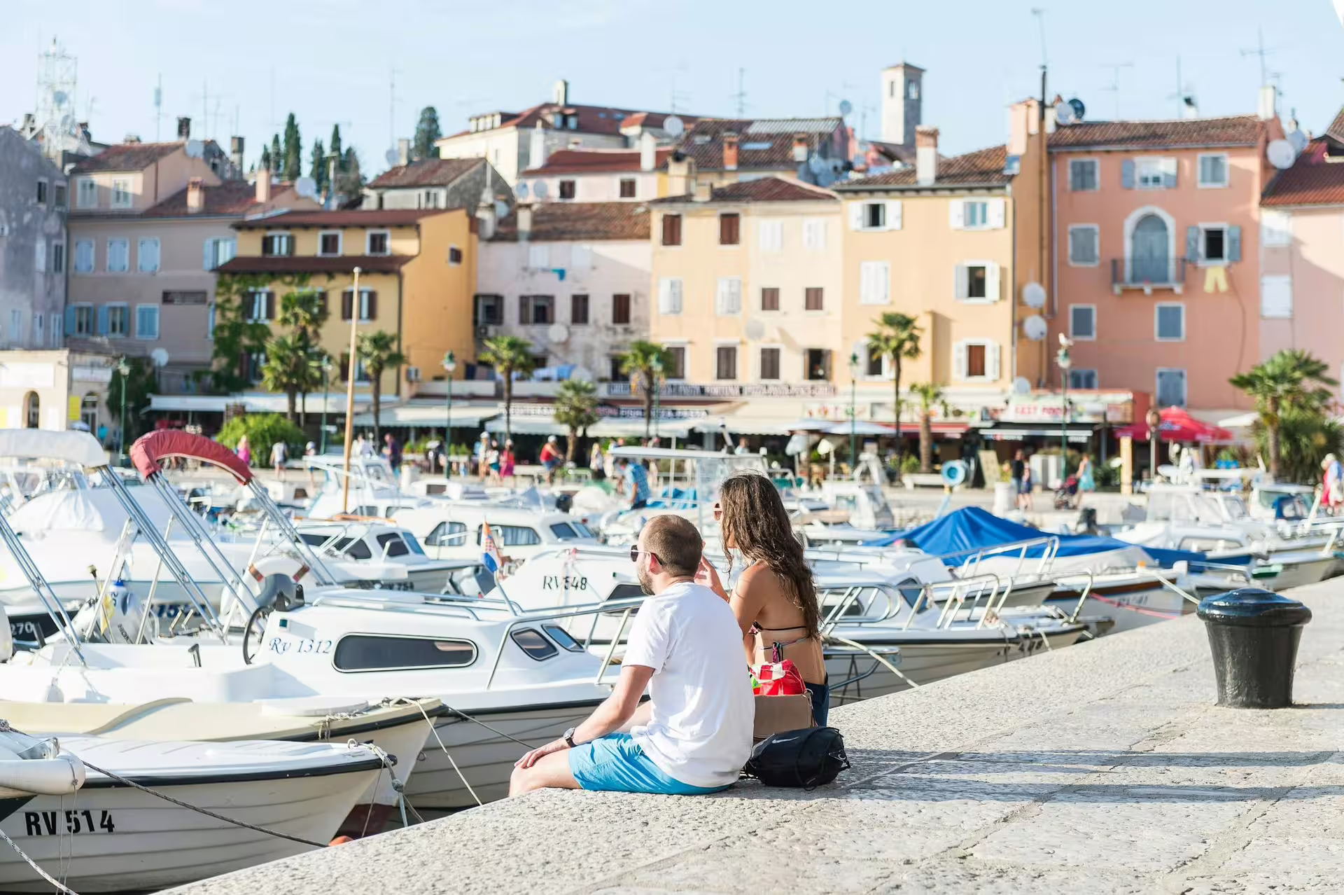 Rovinj harbor promenade with boats and pastel old town, stop on Ancient Istria tour from Poreč