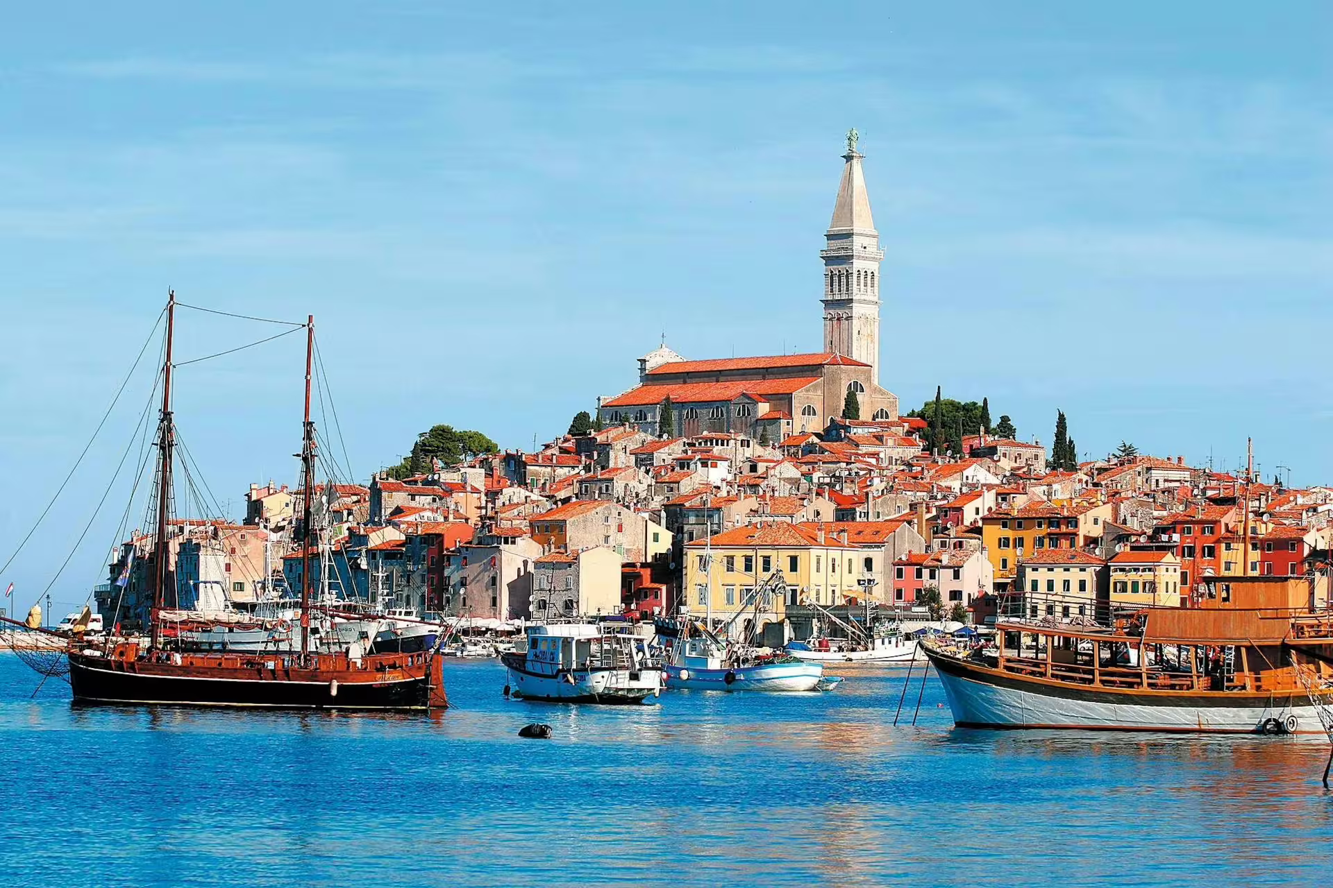 Rovinj harbor panorama with boats and St Euphemia Church, stop on Ancient Istria tour from Poreč