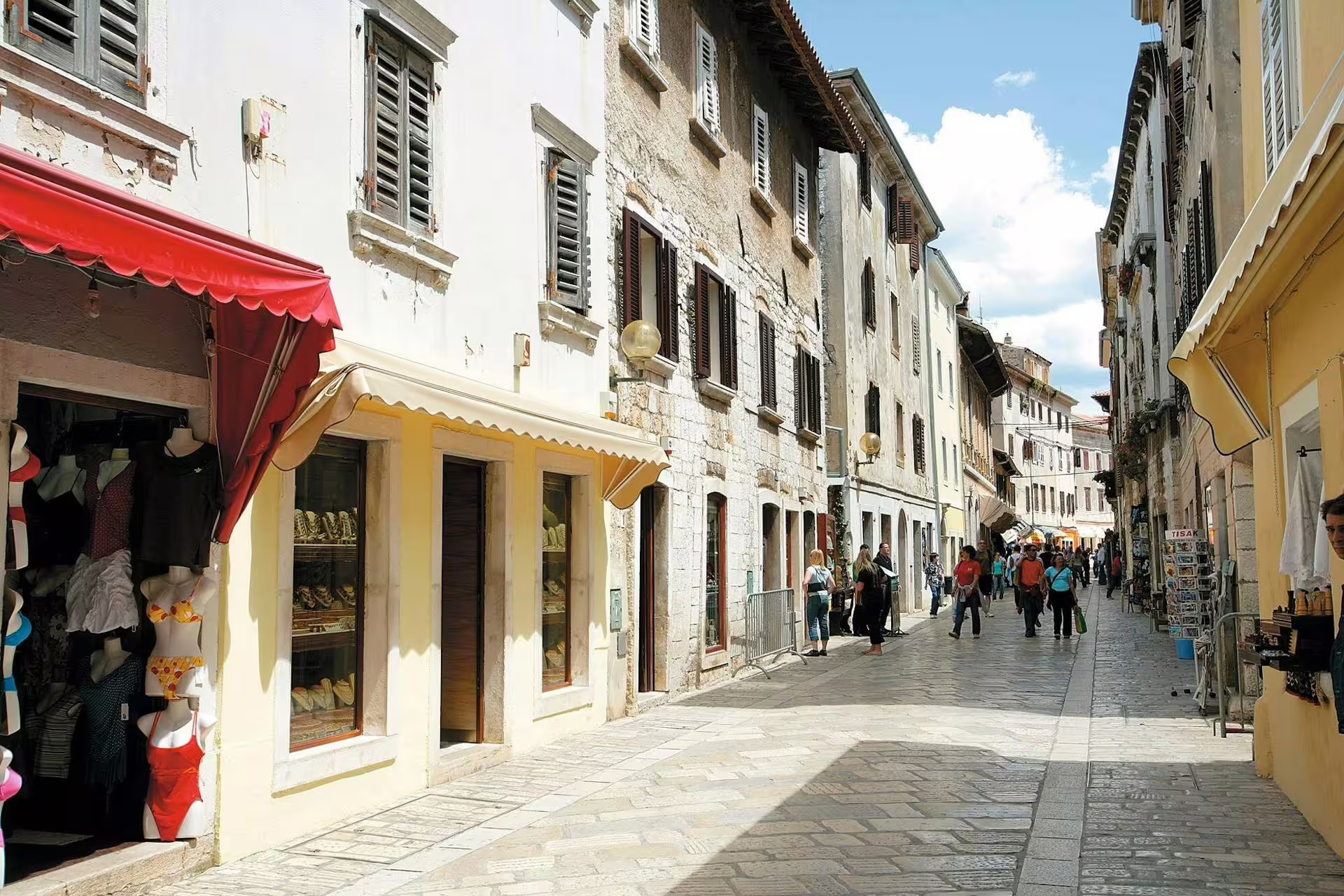 Rovinj old town street with stone houses and shops, a highlight on the Ancient Istria tour from Pula