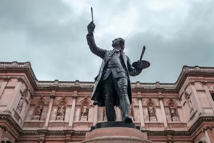 Bronze statue of painter holding palette and brush outside Royal Academy of Arts in Mayfair, London