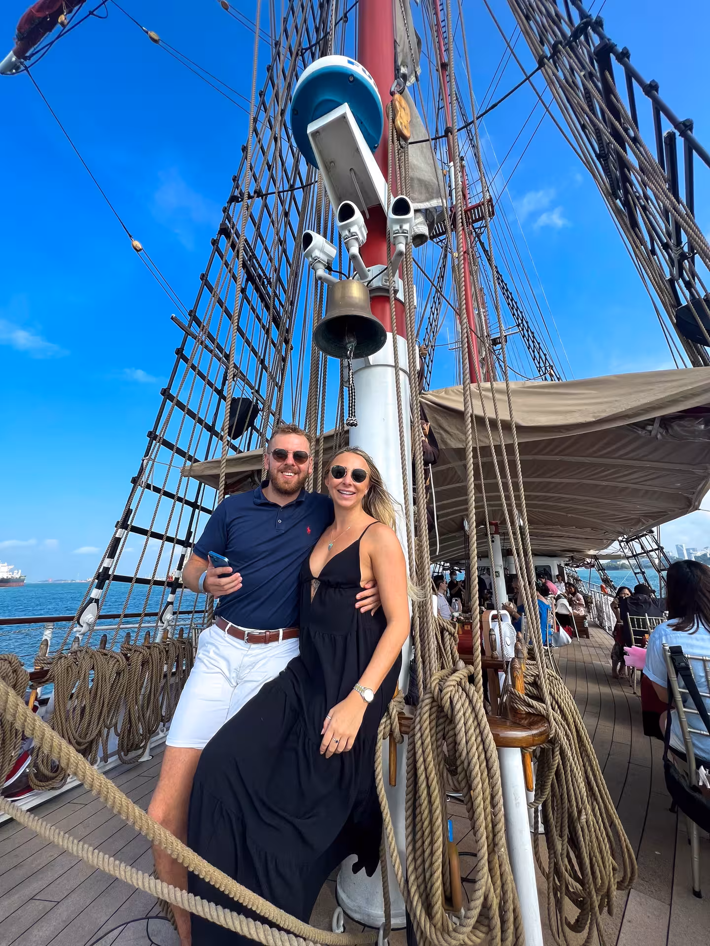 Couple posing on the deck of Royal Albatross, enjoying a sunny, dog-friendly breakfast cruise experience.