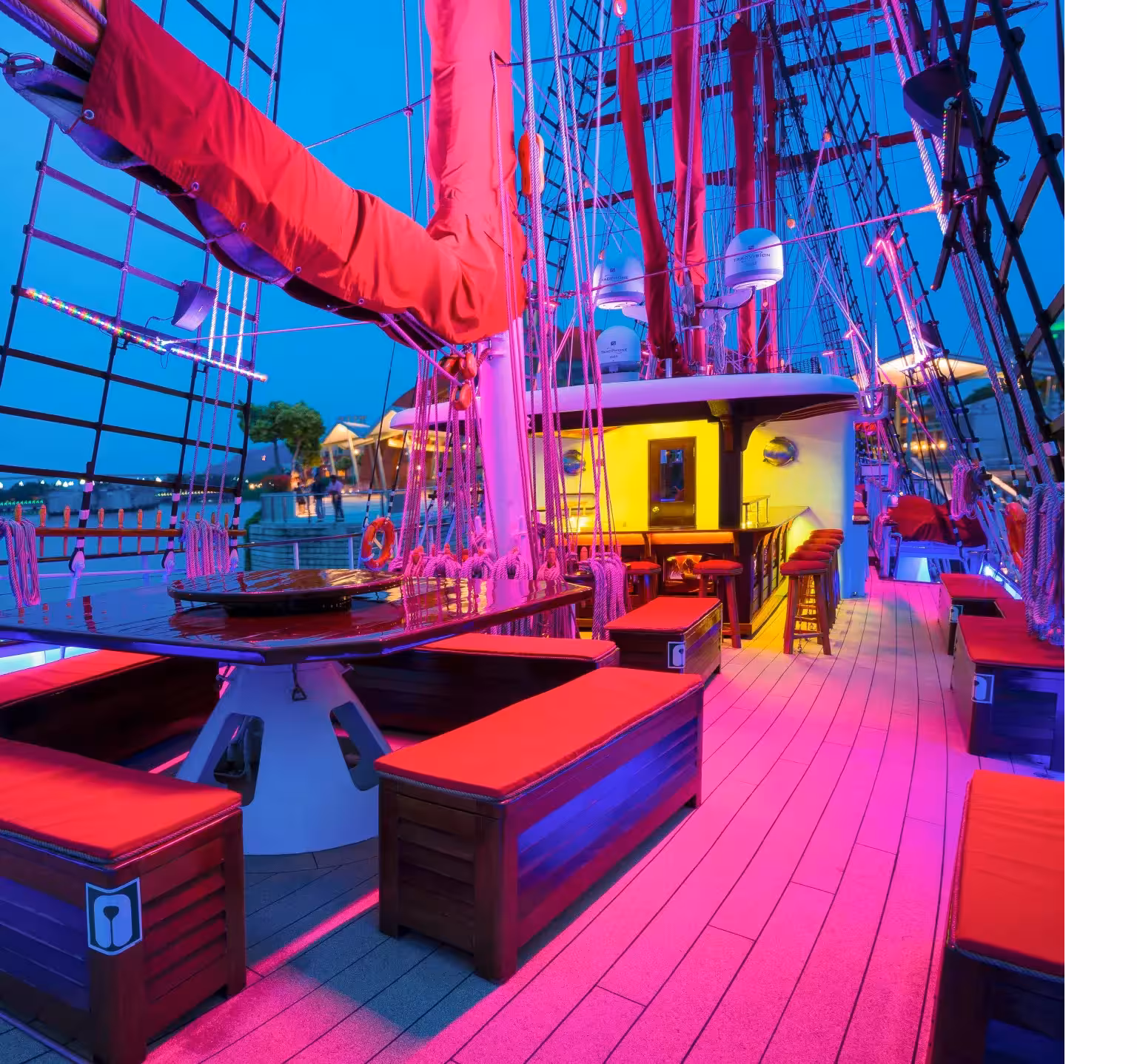 Vibrant deck of the Royal Albatross illuminated for the City Lights Cruise, featuring elegant seating and ambient lighting.