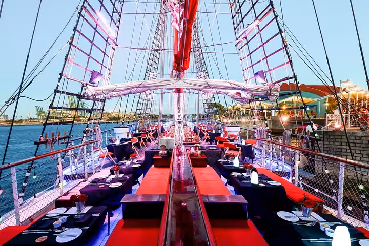 Elegant dining setup on the Royal Albatross ship ready for a sunset cruise with a 5-course dinner experience.