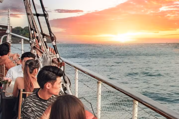 Passengers enjoying a vibrant sunset view from the Royal Albatross, enhancing the luxury dinner cruise experience.