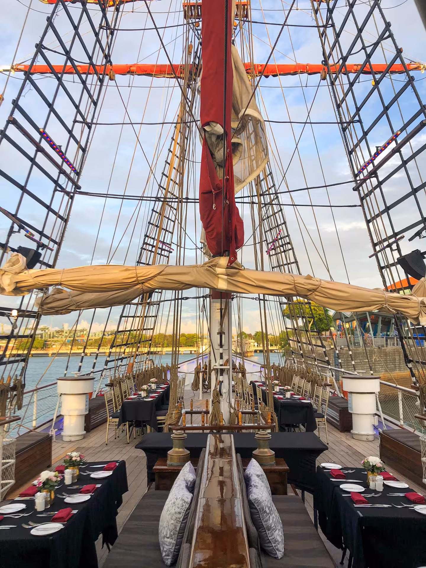 Elegant dining setup on the Royal Albatross deck, ready for a luxurious sunset dinner cruise experience.