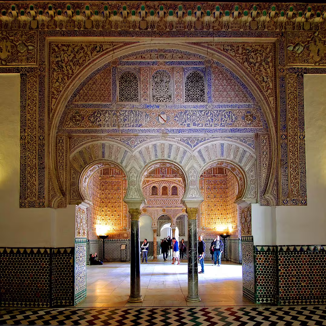 Intricate Moorish arches and ornate tilework at the Royal Alcazar of Seville, highlighting stunning architecture on a private tour.