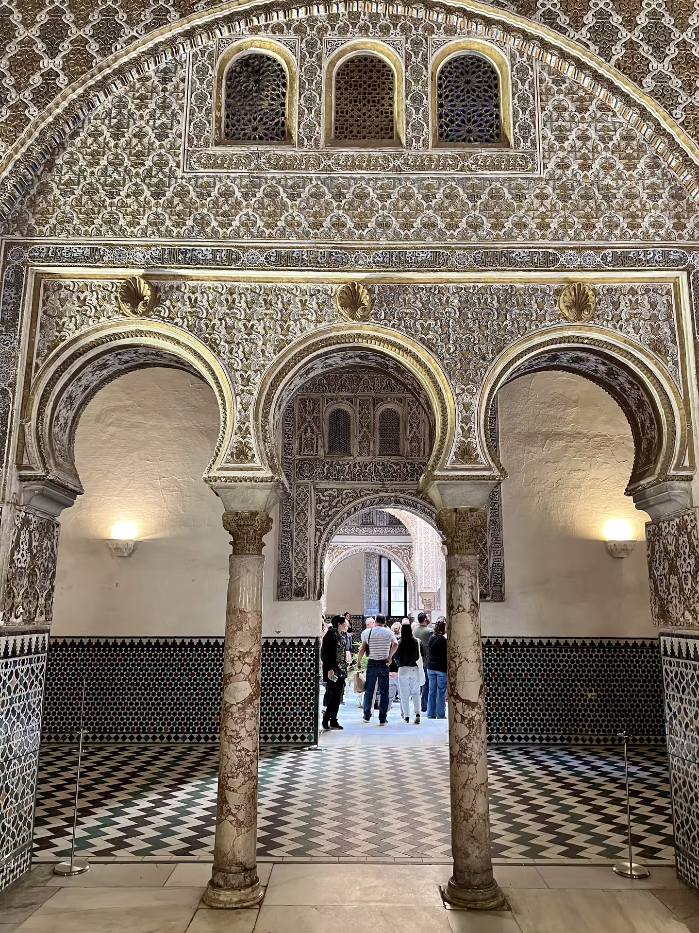 Intricate Moorish arches and detailed tilework inside the Royal Alcazar of Seville, highlighted during a private tour.