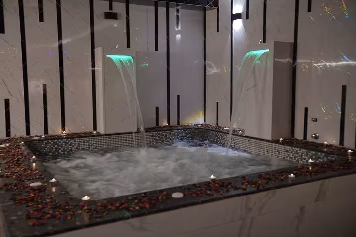 Private jacuzzi pool with waterfalls and candlelight, part of the luxurious Royal Hammam solo spa in Sharm El Sheikh