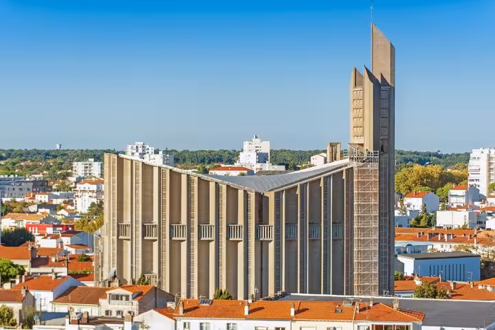 Aerial view of Notre-Dame de Royan brutalist church with tall concrete bell tower in Royan, France