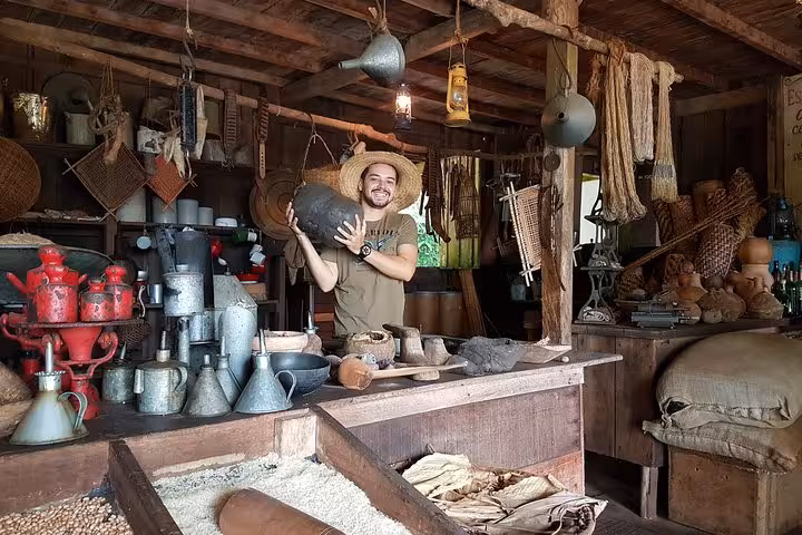 Guide inside Rubber Museum near Manaus showing historic tools and artifacts from Amazon rubber boom