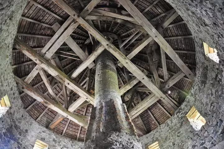 Ancient wooden roof structure with central pillar inside Rupea Fortress tower, Brasov region