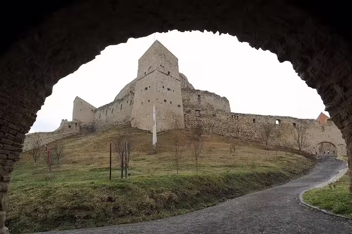 Rupea Fortress medieval stone walls and tower viewed through an arched gateway in Brasov, Romania