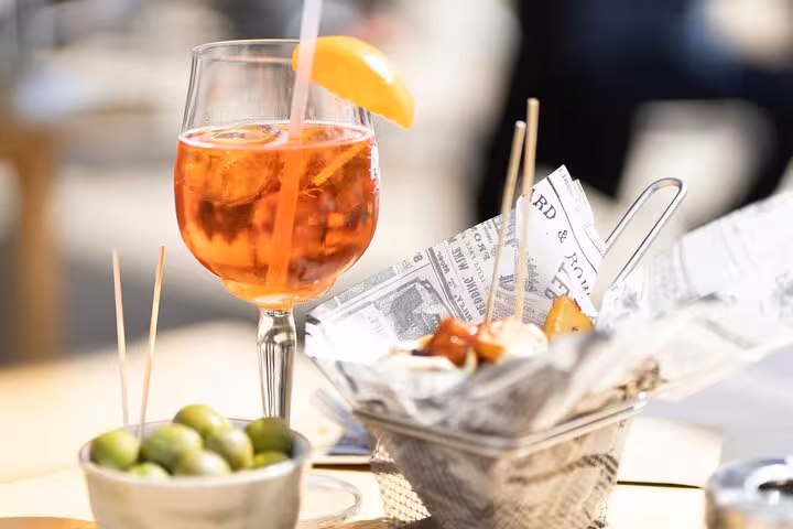 Aperol spritz with olives and tapas bites on a table, perfect for a Ruzafa food and wine tour