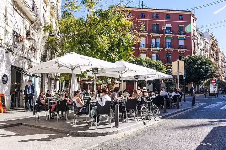 Outdoor terrace in Ruzafa Valencia with locals dining, ideal scene for evening tapas drinks and wine tour