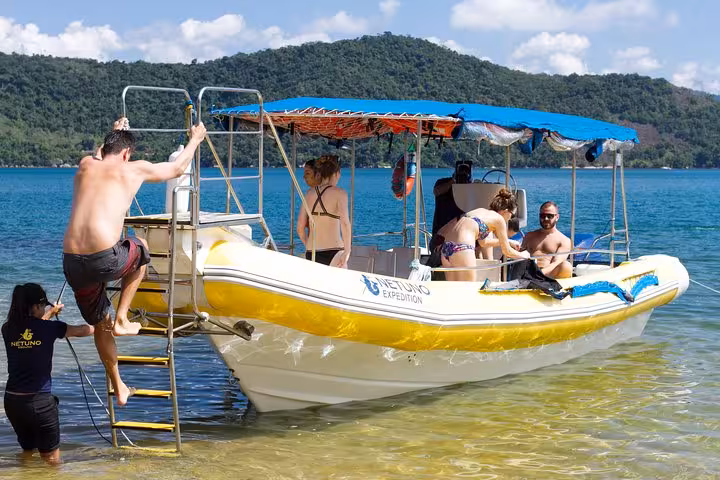 Tourists boarding a boat for a half-day adventure to the idyllic beaches of Saco Mamanguá Fjord.