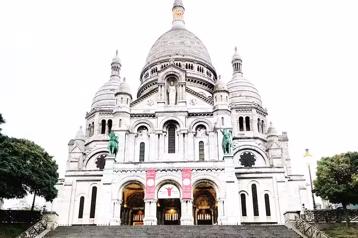 Sacré-Cœur Basilica white stone facade with domes and steps in Montmartre Paris