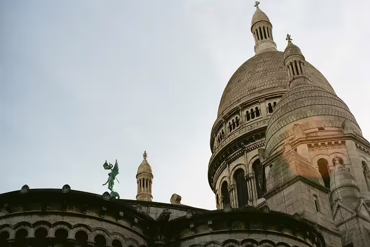 Sacré-Cœur Basilica dome and angel statue in Montmartre Paris