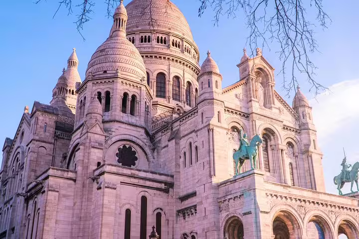 Sacré-Cœur Basilica facade with equestrian statue at golden hour, Montmartre Paris