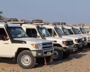 Fleet of white Toyota Land Cruiser 4x4 jeeps lined up for desert safari in Safaga Egypt