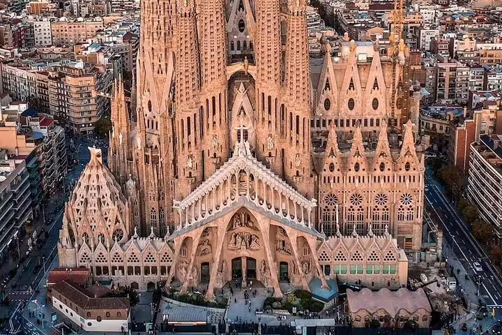 Aerial view of Sagrada Família basilica surrounded by Barcelona cityscape on a clear day